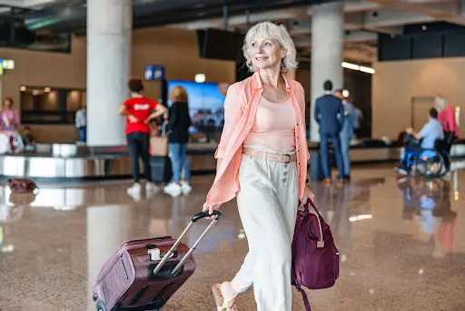 Woman Traveling with Luggage at Airport