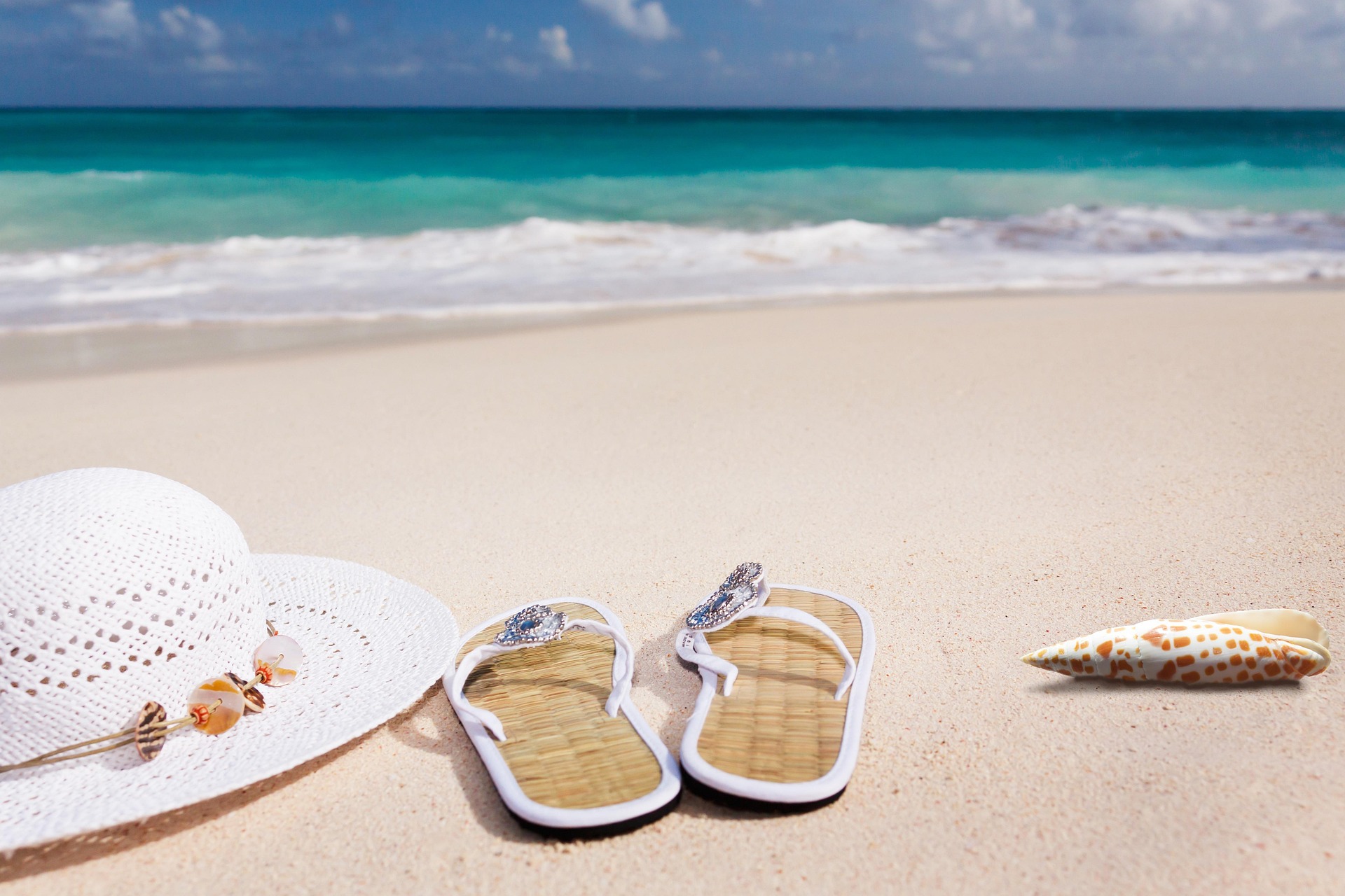 Sun hat, sandals and a shell
